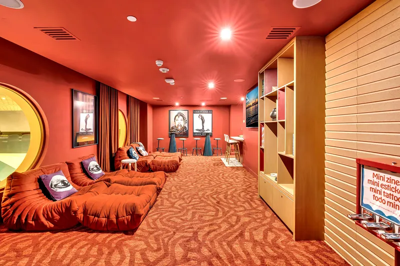 Red cinema room with low lounge seating